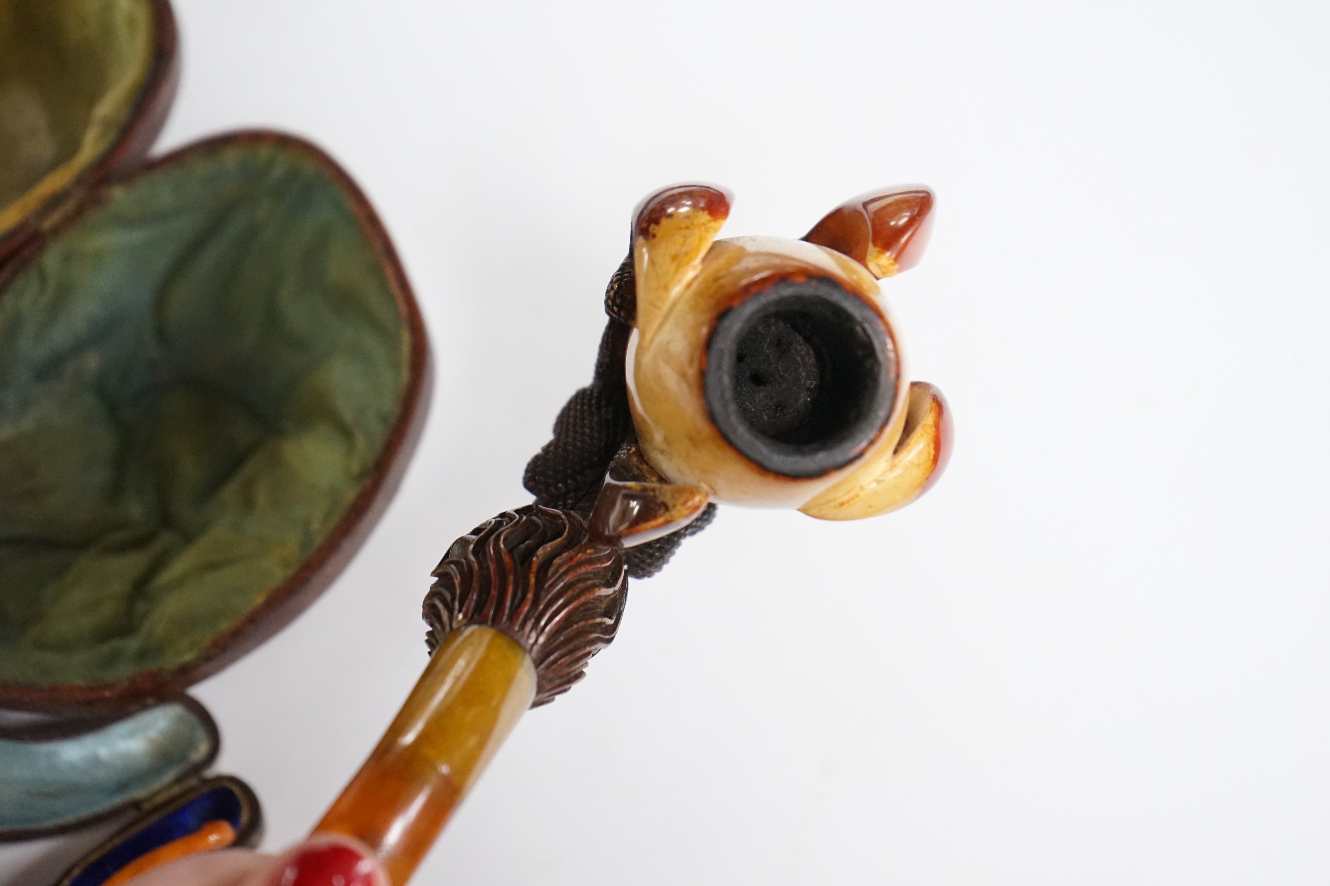 Two novelty Meerschaum pipes both with dragon claw talon pipe bowls and amber mouthpieces, largest 17cm long